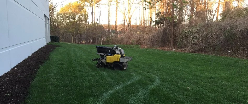 Fertilizer spreader on a green lawn in Bethlehem, GA.