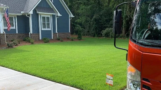 Solid Green Lawn & Landscape truck at customer's home.
