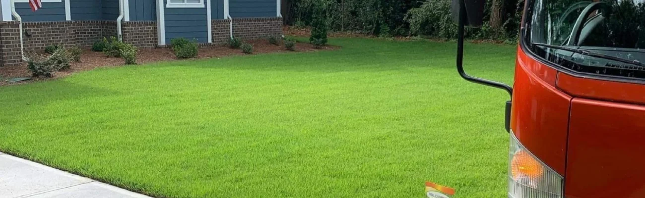 green lawn with red Solid Green truck